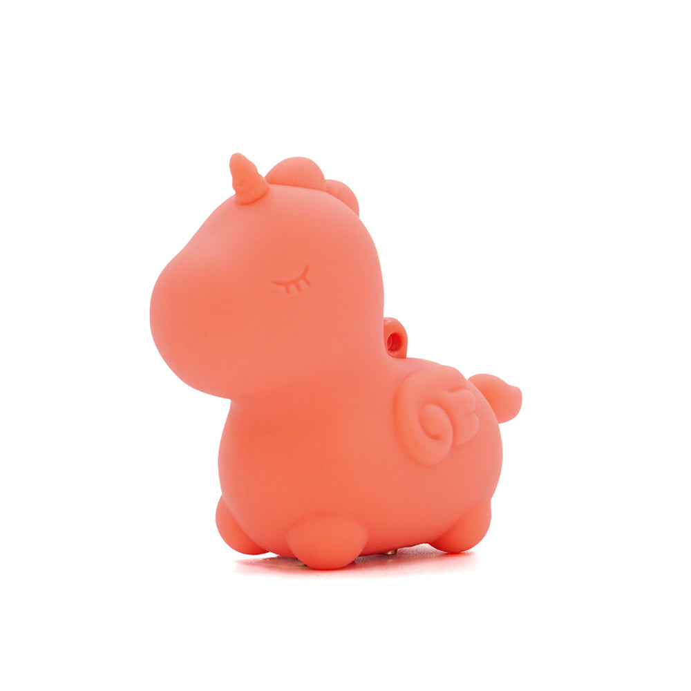 Orange silicone unicorn toy with closed eyes and a horn.