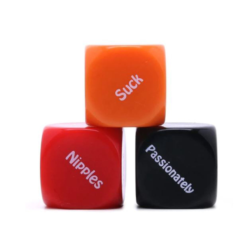 Three erotic dare dice with words "Suck", "Nipples", and "Passionately" on them.