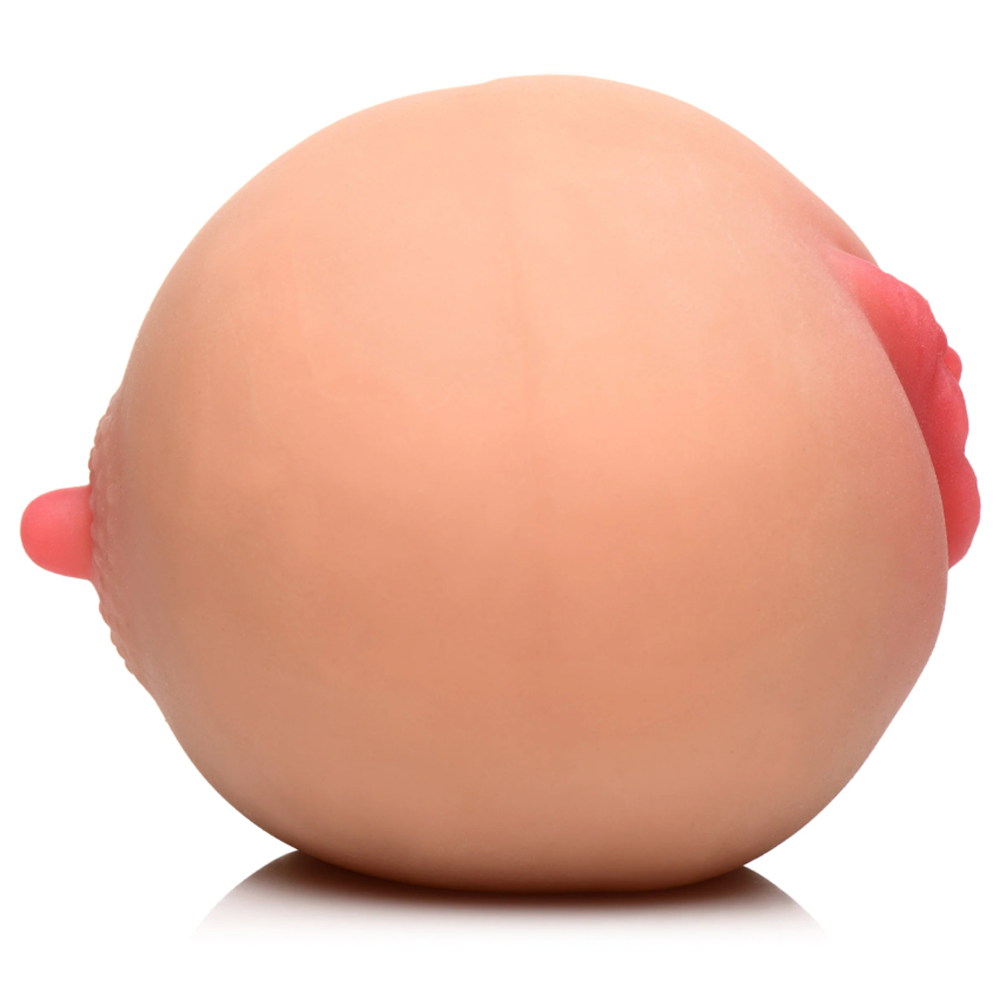Realistic breast-shaped masturbator with dual textures.