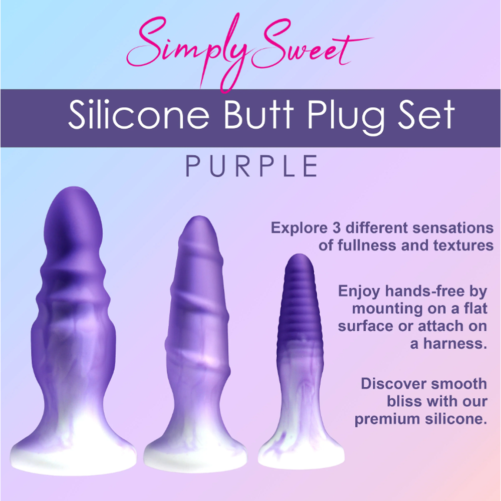 Three purple silicone butt plugs with textured surfaces and flared bases.