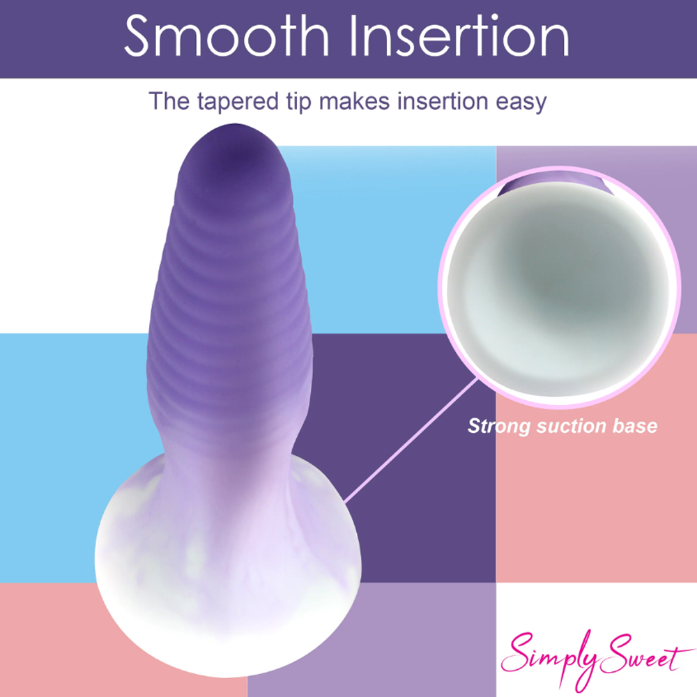 A purple ribbed silicone butt plug with a suction base.