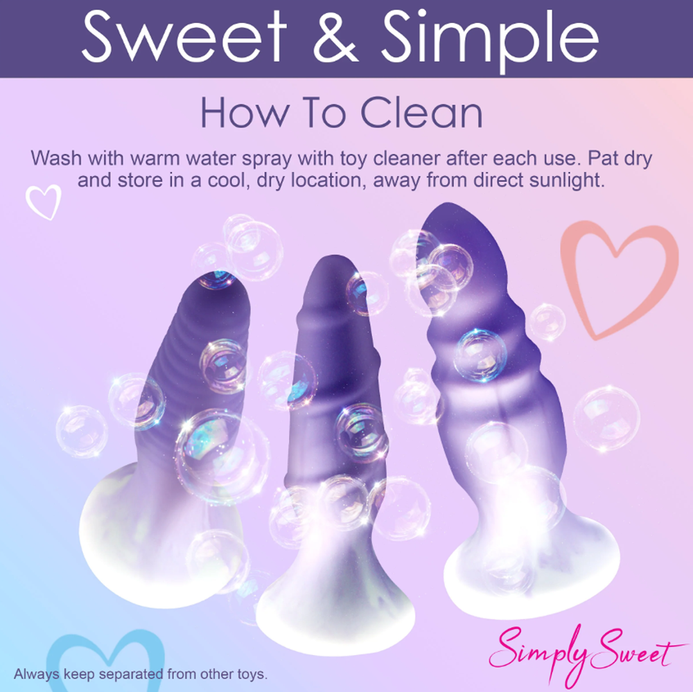 Three purple textured silicone butt plugs with bubbles and hearts.