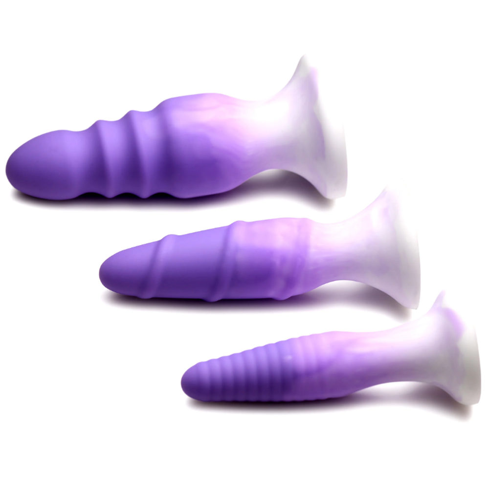 Three textured purple and white silicone butt plugs with suction bases.