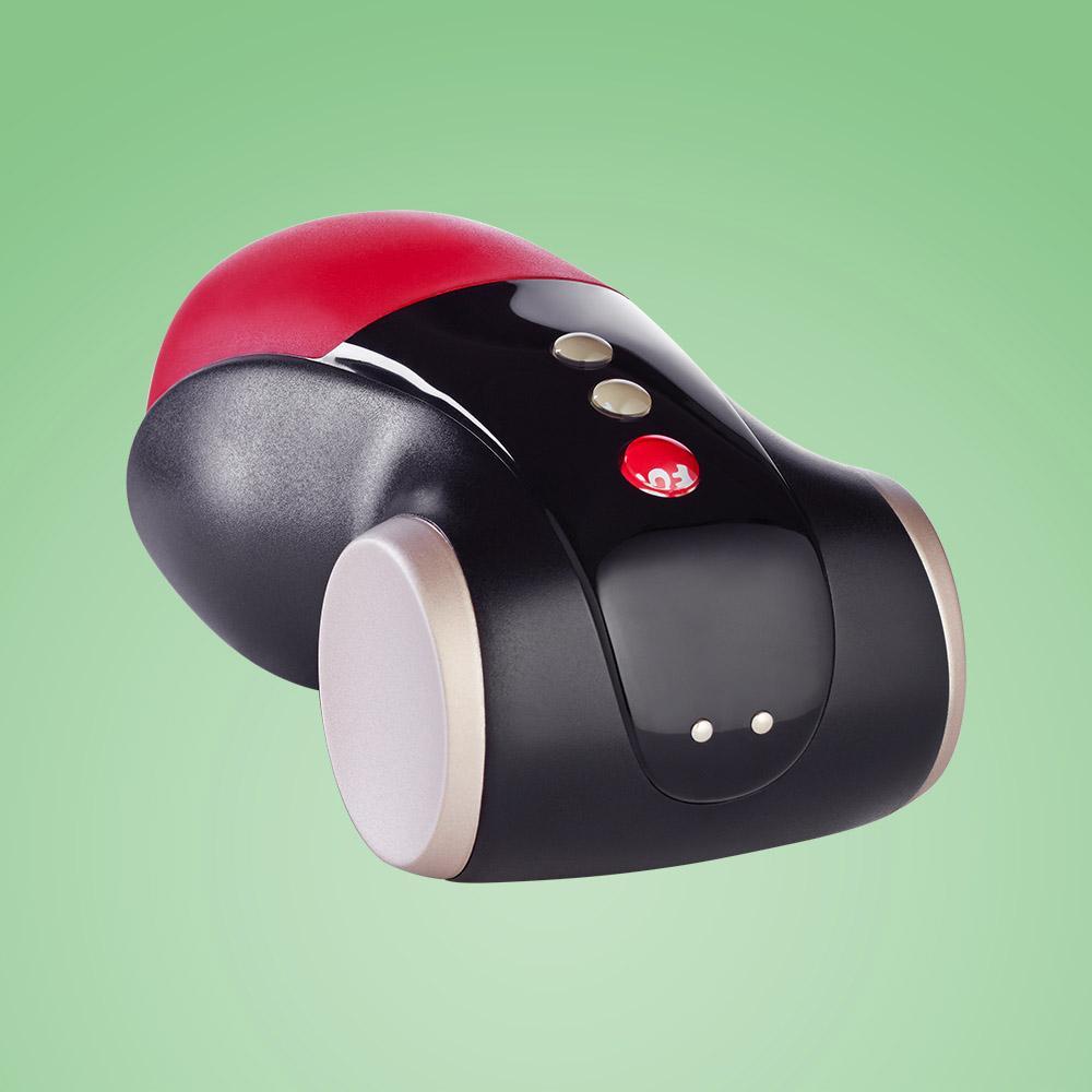 A black and red vibrating masturbator with gold accents.