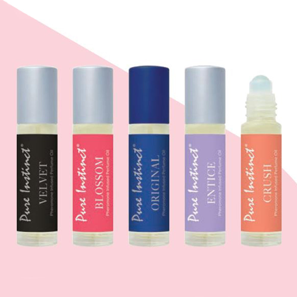 Five Pure Instinct pheromone perfume oil roll-ons in different colors and scents.