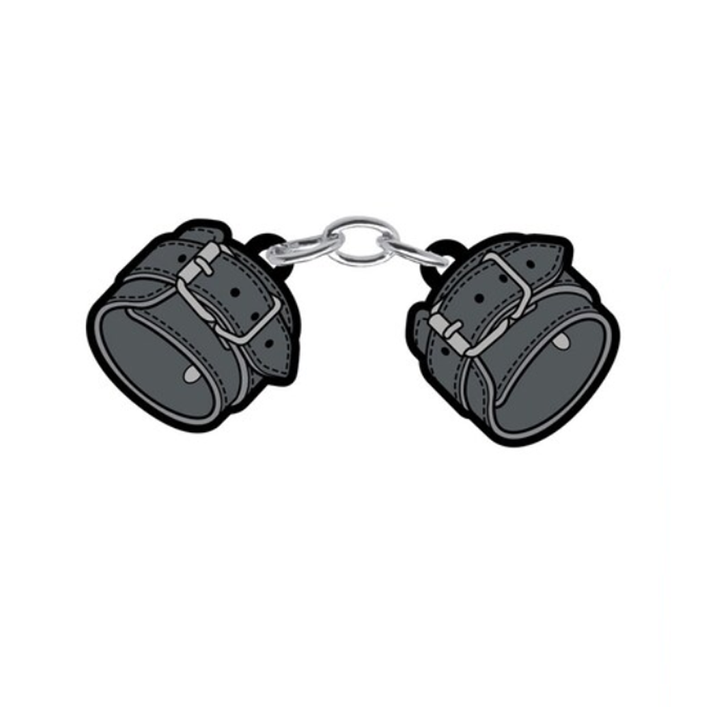 Soft enamel lapel pin resembling large leather handcuffs.