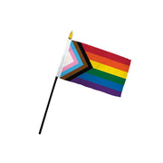 Progress Pride stick flag with a gold spear on a black pole.