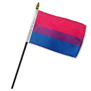 A bisexual pride flag on a black stick with a gold spear topper.