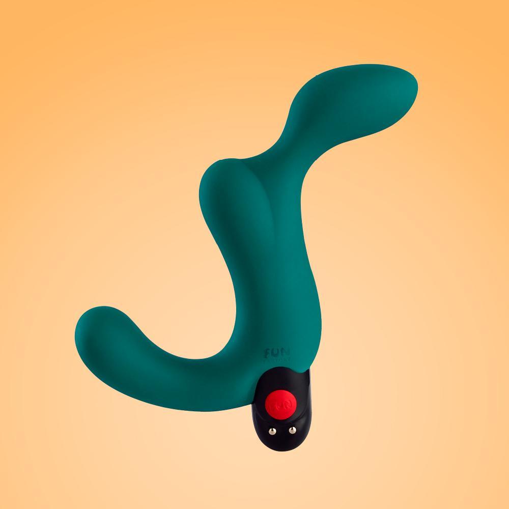 A teal vibrating prostate plug with a curved design and a red button.