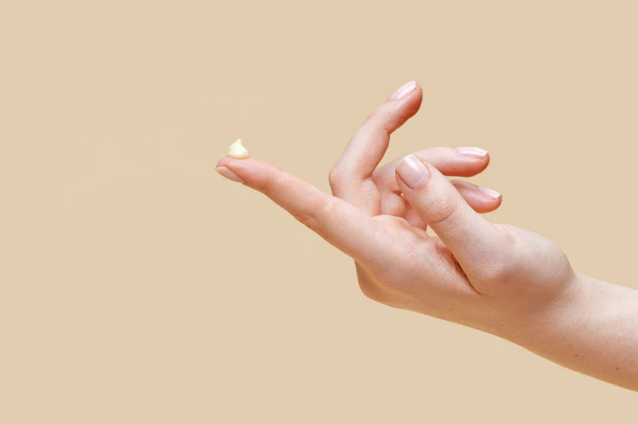 A hand with a dollop of arousal serum on the fingertip.