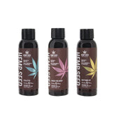 Three bottles of Hemp Seed massage oil with cannabis leaf designs in blue, pink, and yellow.