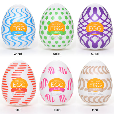 Six egg-shaped Tenga masturbators with different textures and colors.