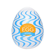 Tenga Egg Wind textured male masturbator with blue wavy pattern.