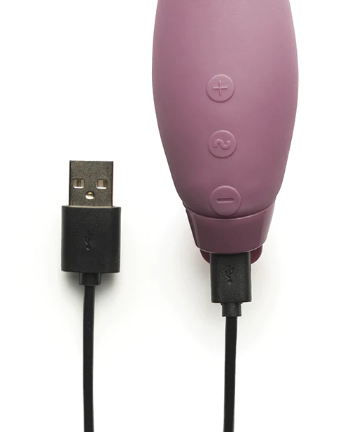 A purple vibrator with a USB charging cable.
