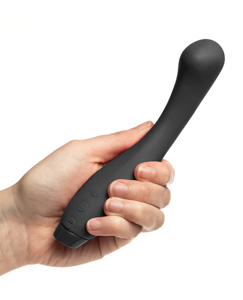 Black flexible silicone vibrator held in a hand.
