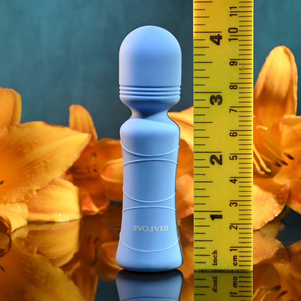 A blue mini wand vibrator with a ruler showing its size.