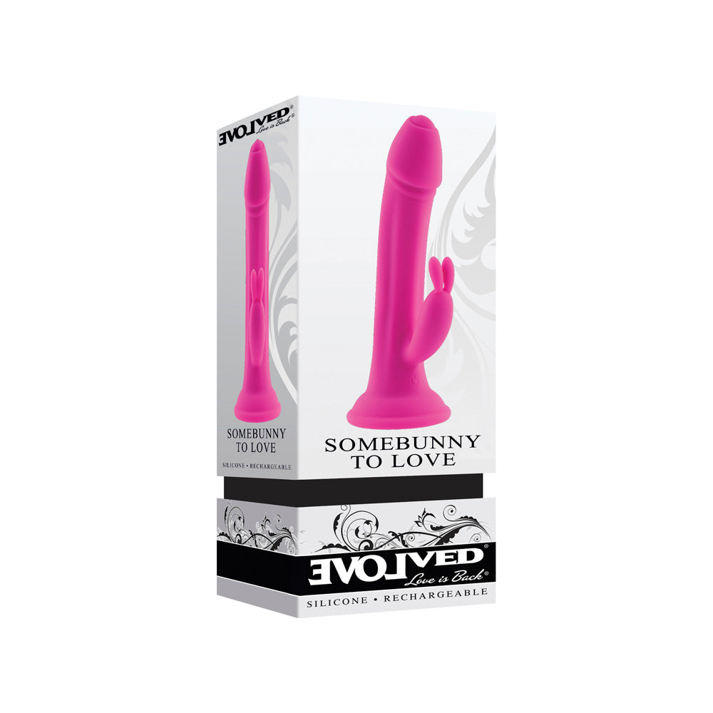 A pink silicone vibrator with rabbit ears on a box.