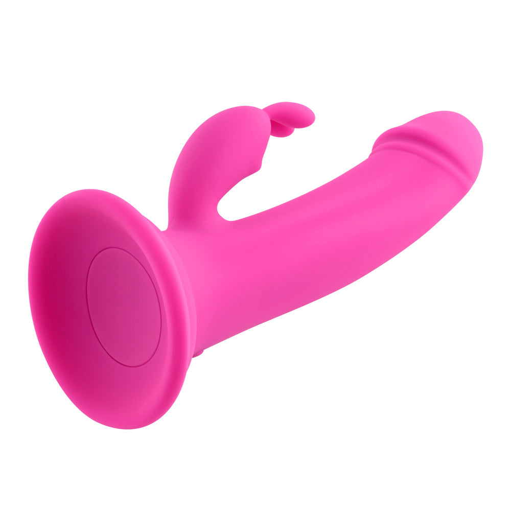 Pink rechargeable silicone rabbit vibrator with dual motors and suction cup base.