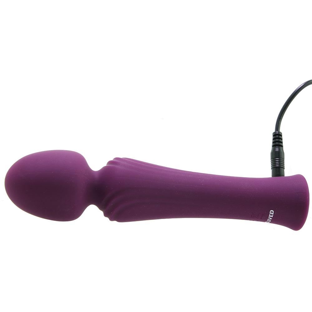 Purple silicone vibrator with a textured shaft and a charging cable.