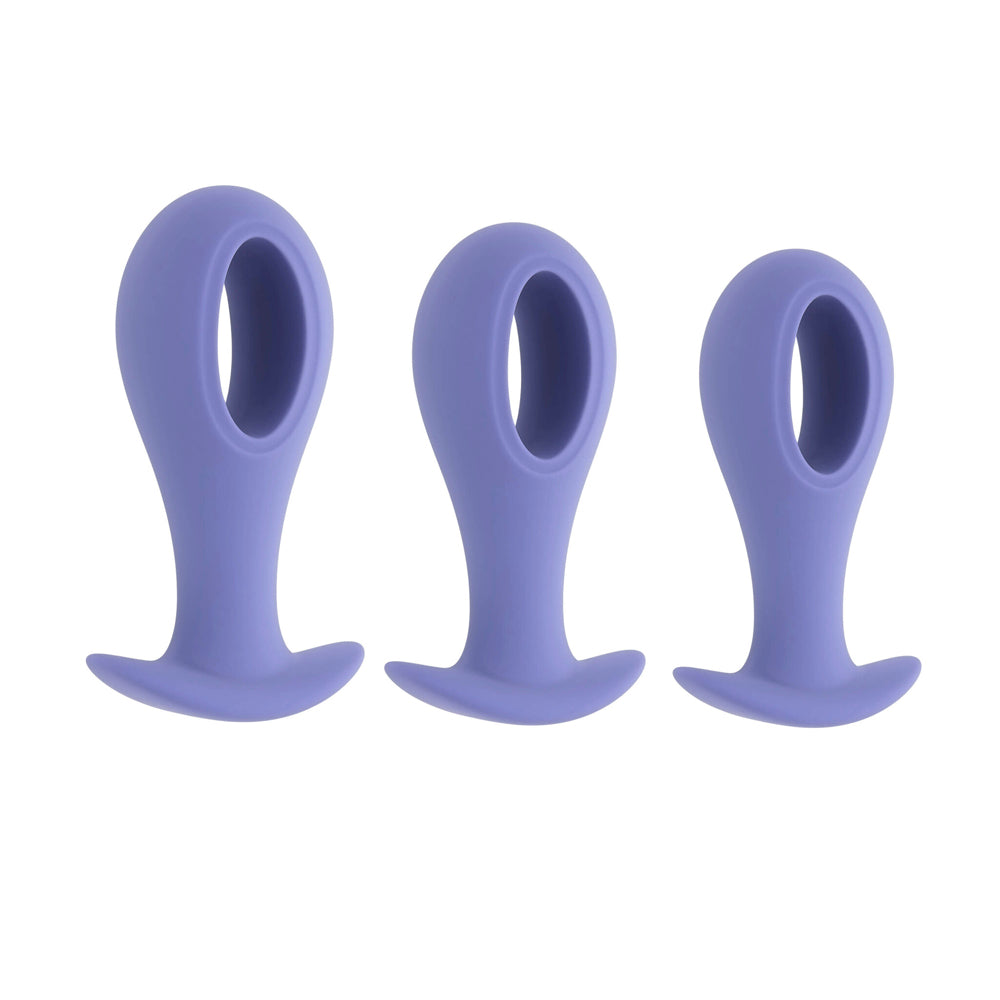 Three purple silicone anal plugs of varying sizes.