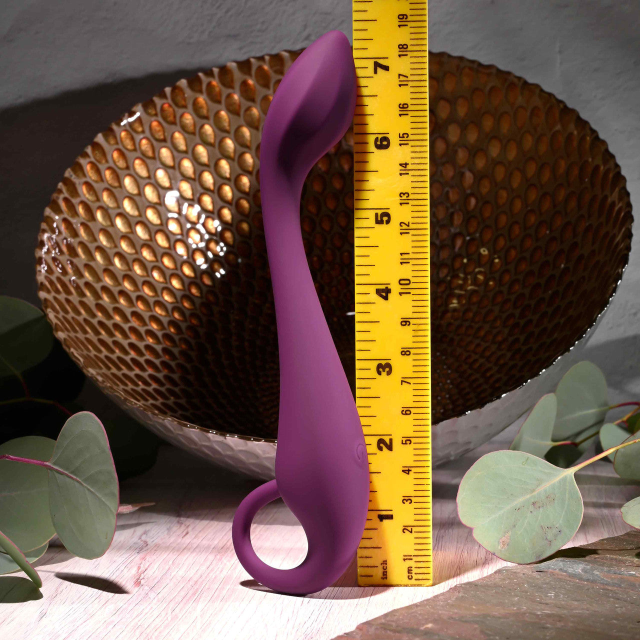 A purple G-spot vibrator with a curved shaft and ring handle.