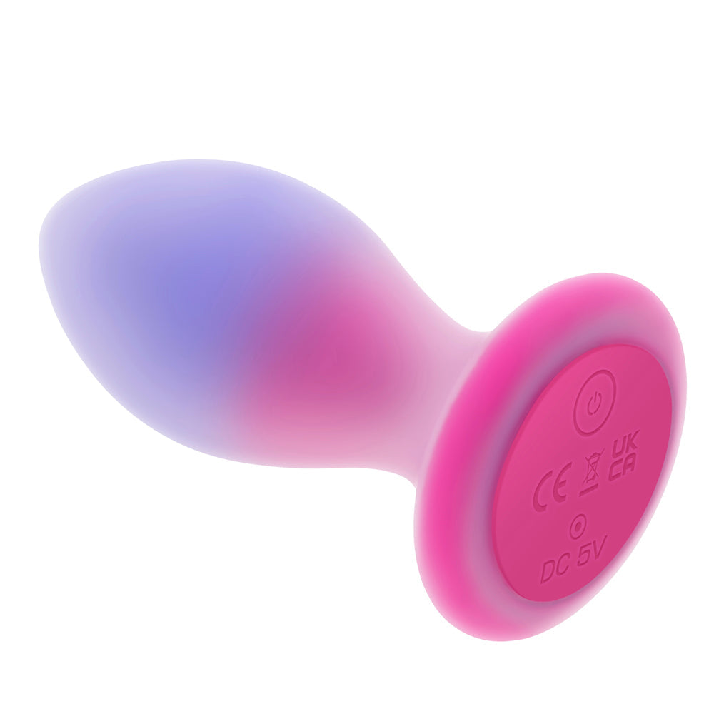 A silicone anal plug with a gradient of purple and pink, featuring a pink base with power and charging indicators.