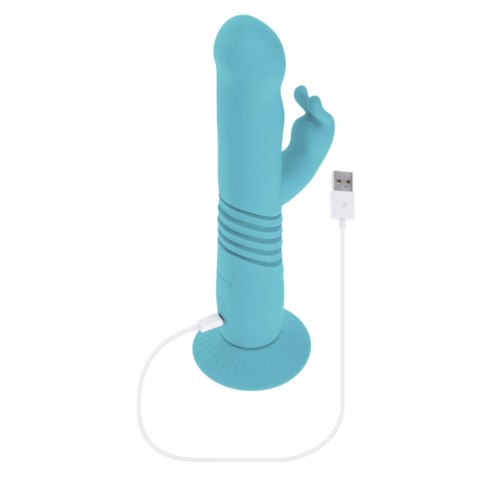 A teal rabbit vibrator with a suction cup base and USB charging cable.