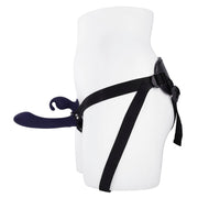 A dark purple strap-on vibrator with a curved shaft and bunny ears attached to a black harness.