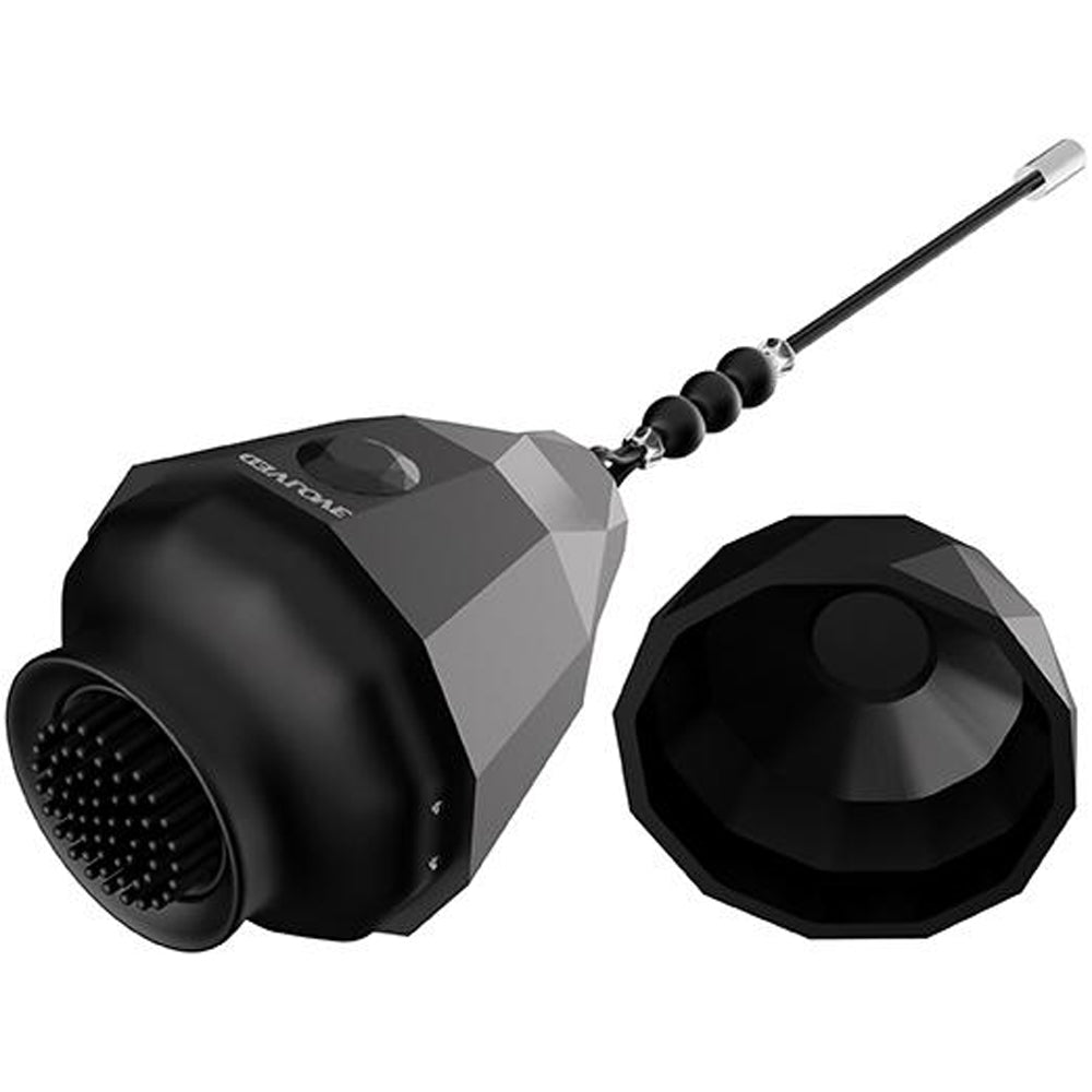 Black spinning clitoral stimulator egg with a textured surface and a silicone brush.