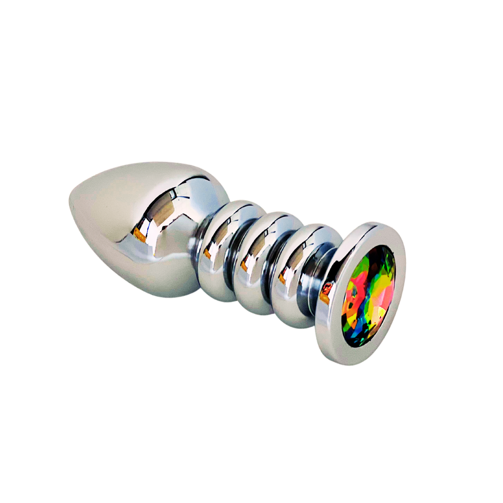 A silver anal plug with ribbed detailing and a colorful gem at the base.