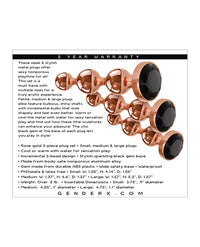 Rose gold metal anal plugs with black gem bases in three sizes.