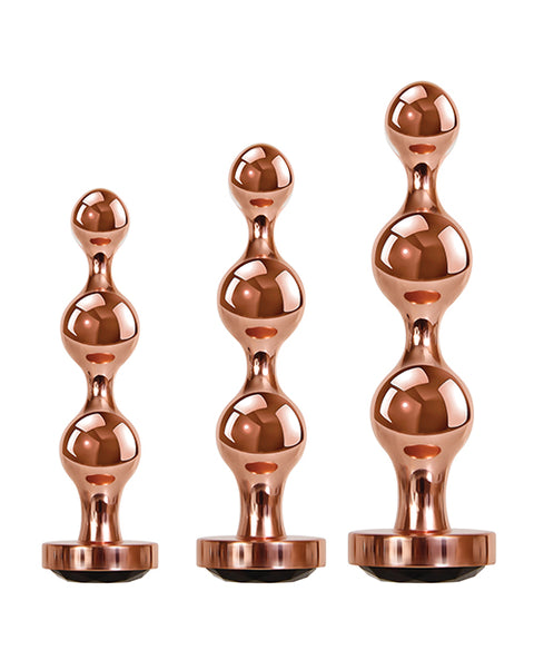 Three rose gold metal anal plugs with rounded beads and black gem bases.