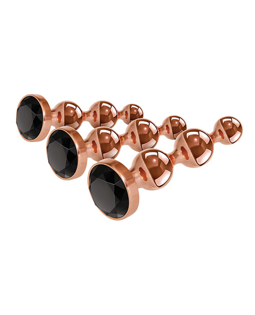 Rose gold metal anal plugs with black jewels.