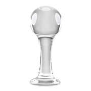Clear glass anal plug with a spherical head and flared base.