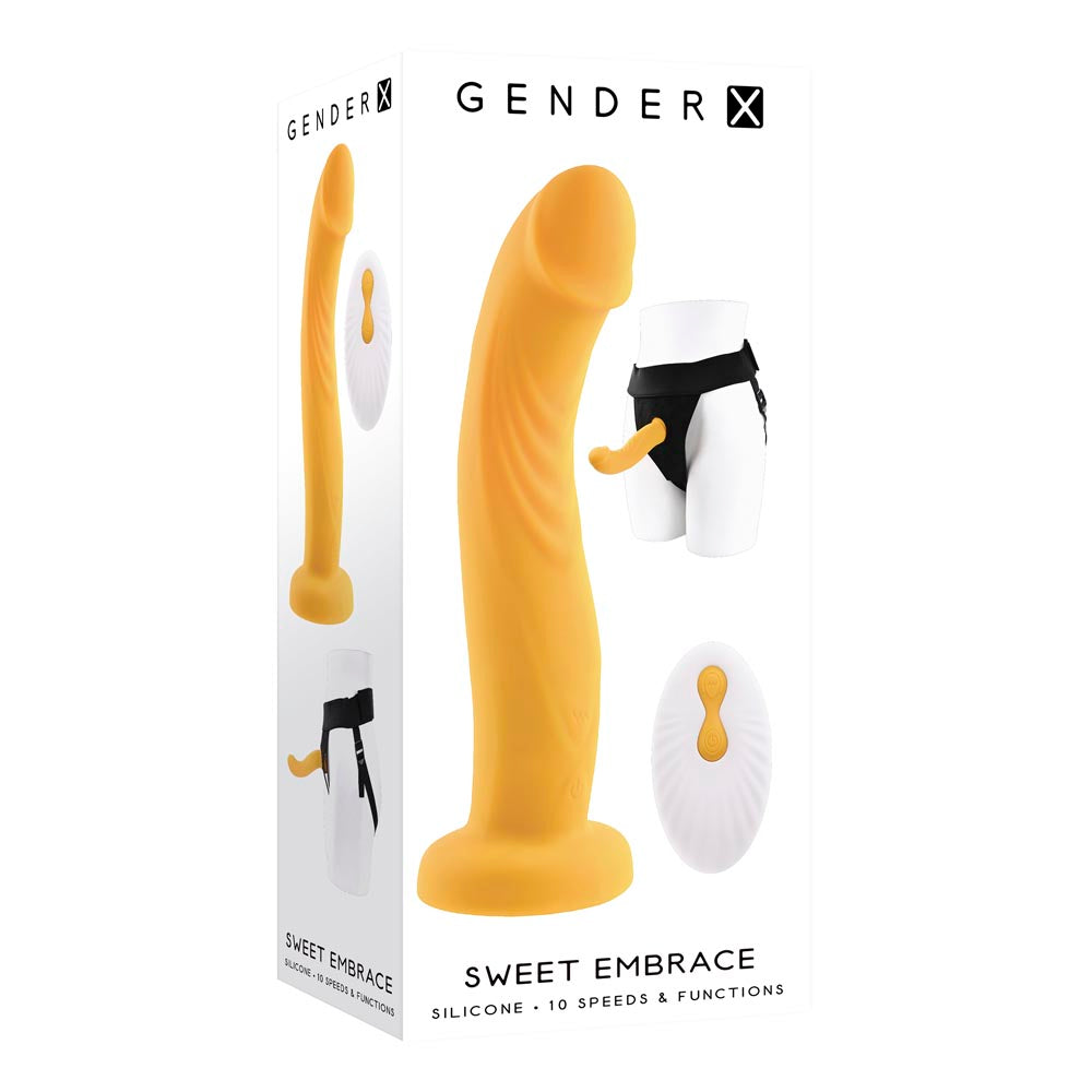 Orange silicone dual-motor strap-on dildo with remote control and adjustable harness on product box.