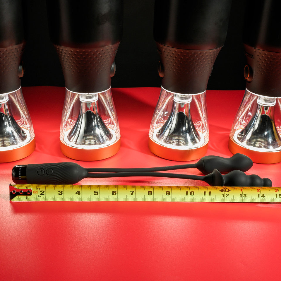 Black and orange dual motor silicone rechargeable vibe with a beaded plug and mini-vibe.