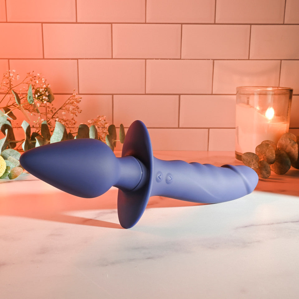 A purple dual-ended vibrator with a flared base and textured handle.