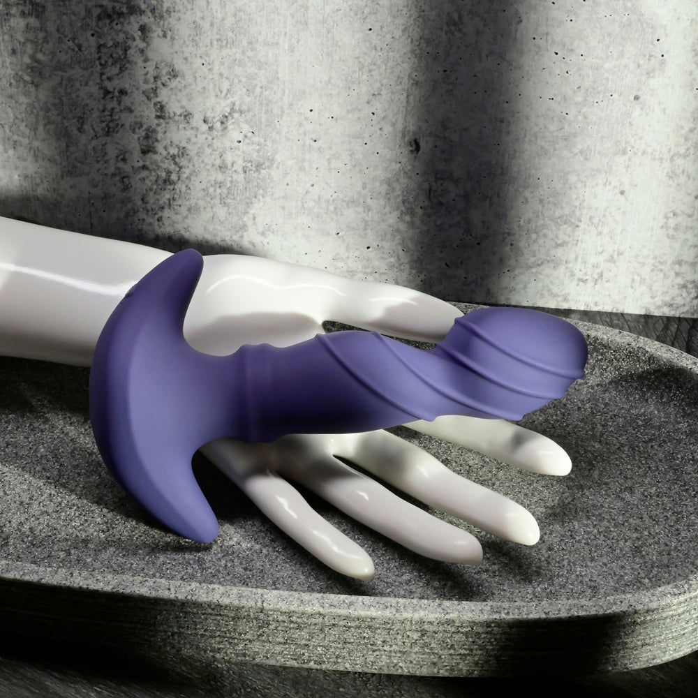 Purple ribbed vibrator with a T-shaped handle on a mannequin hand.