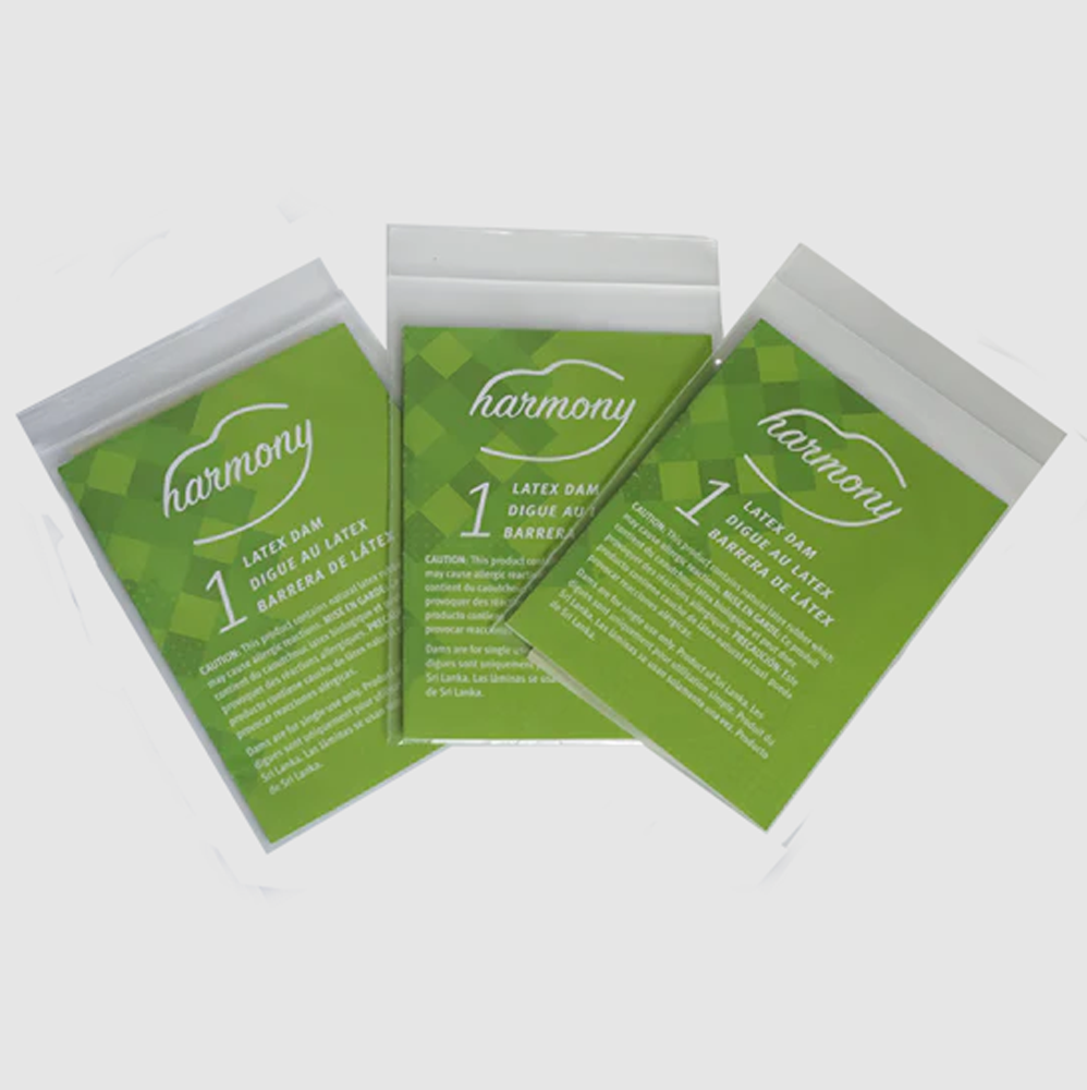 Three individually packaged Harmony latex oral dams with green labels.