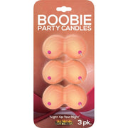Three boobie-shaped novelty candles with pink nipples on a card.