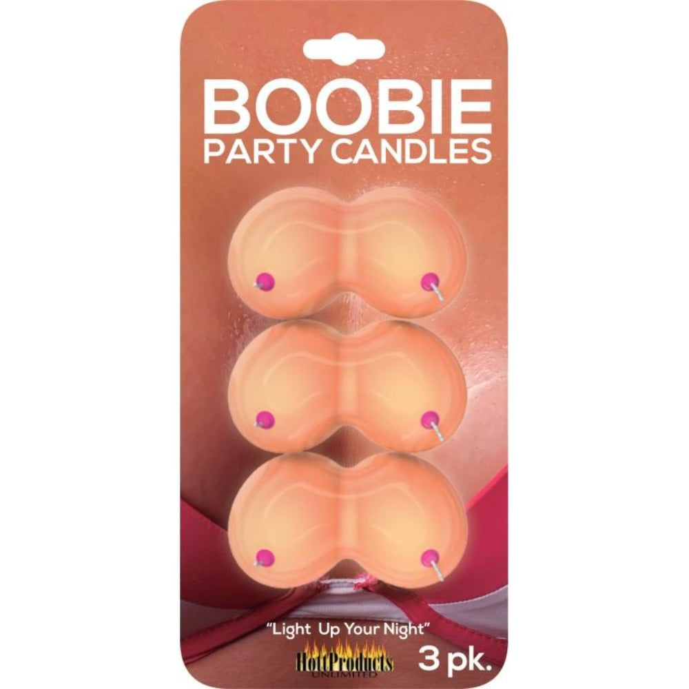 Three boobie-shaped novelty candles with pink nipples on a card.