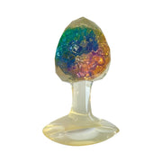 A clear silicone butt plug with a faceted, colorful gem-like top.