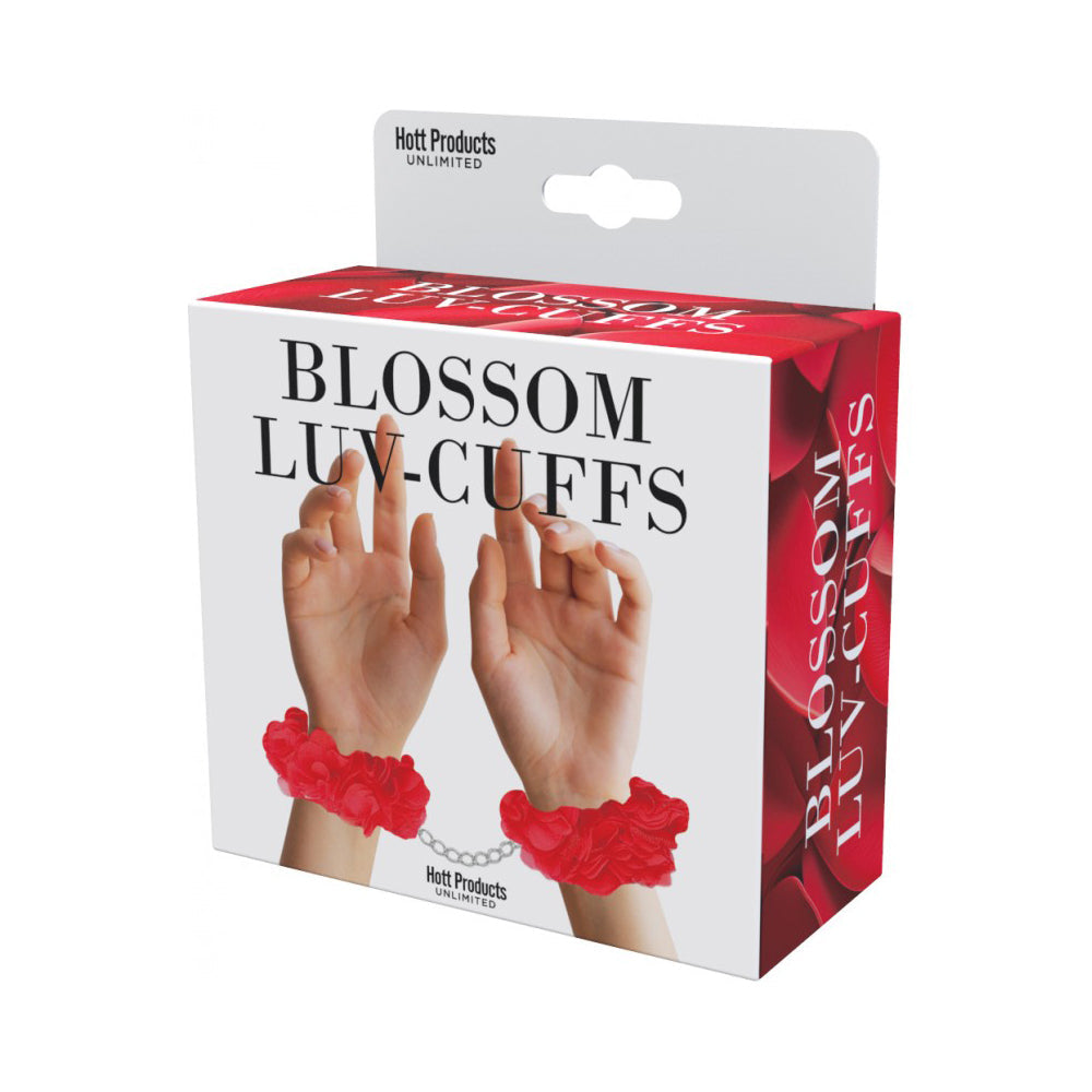Red soft handcuffs with flower details on a white box.