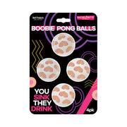 Four novelty beer pong balls with a boobie design.