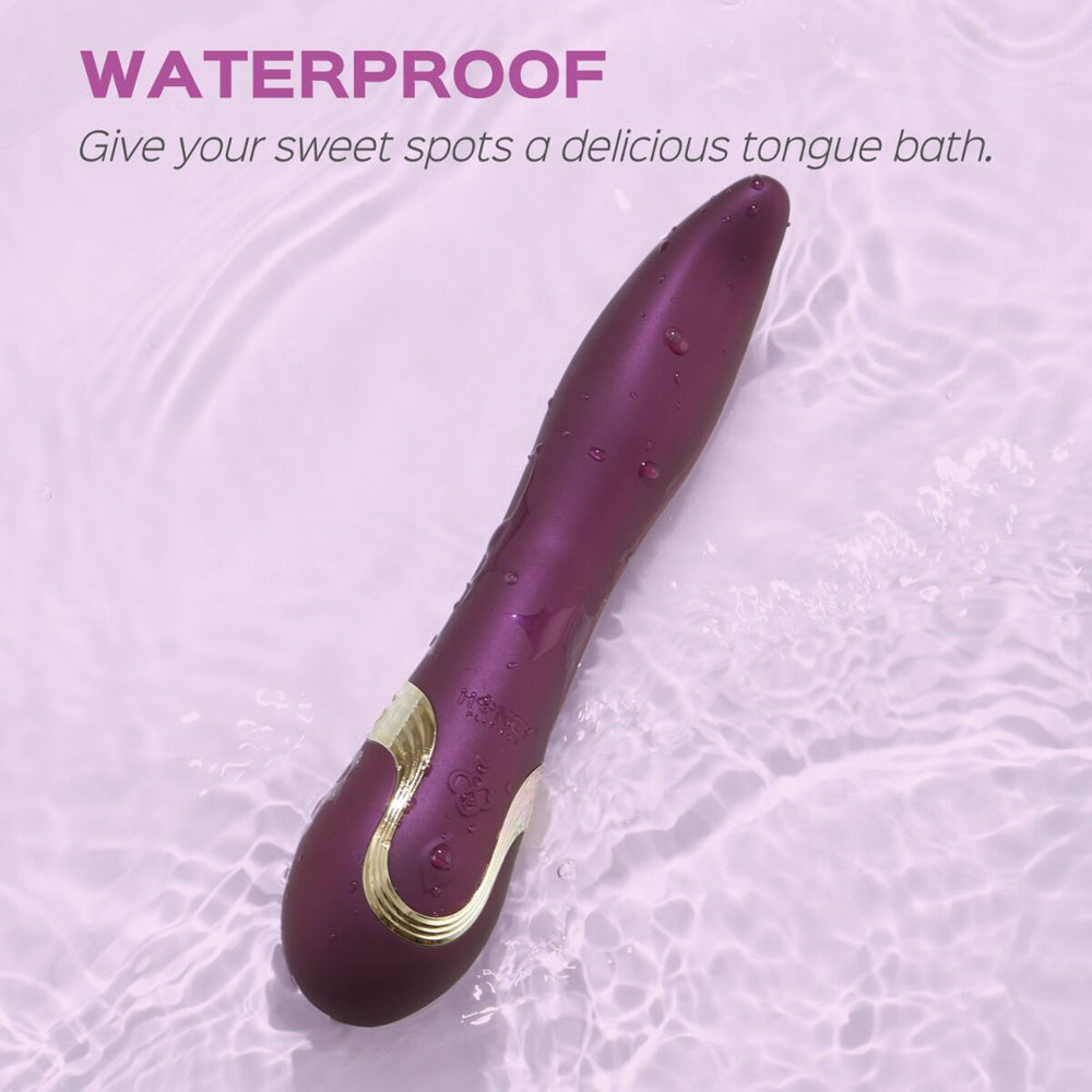 A purple, waterproof vibrator with gold accents rests in rippling water.