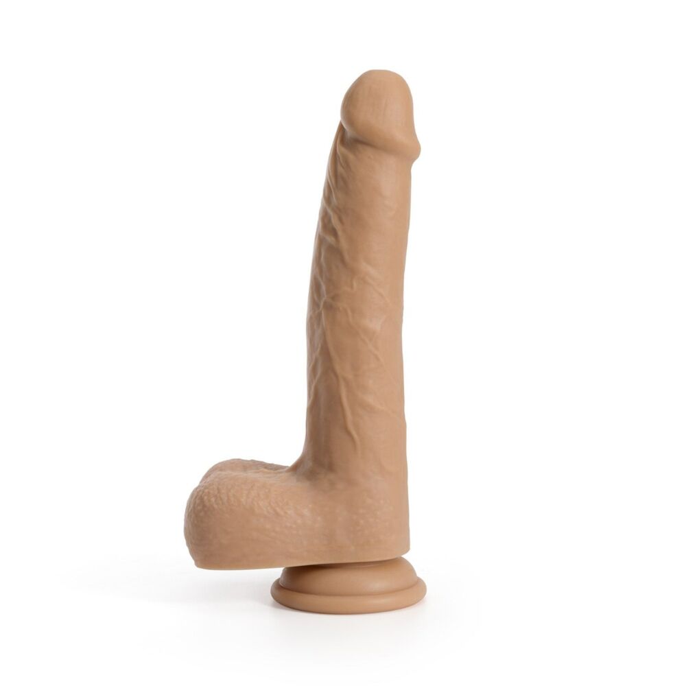 A side view of a realistic tan silicone dildo with suction base, thrusting and rotating features, and remote control.