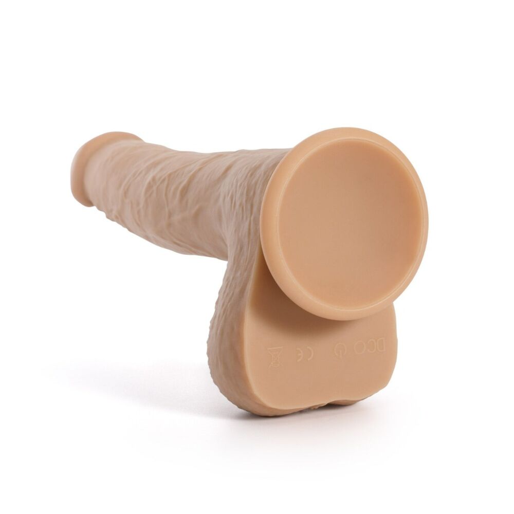 Beige silicone thrusting and rotating dildo with suction base and remote.