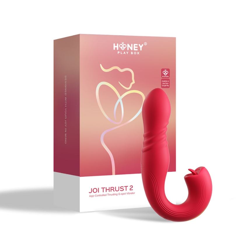 A red Joi Thrust 2 vibrator with a curved design, next to its Honey Play Box packaging.