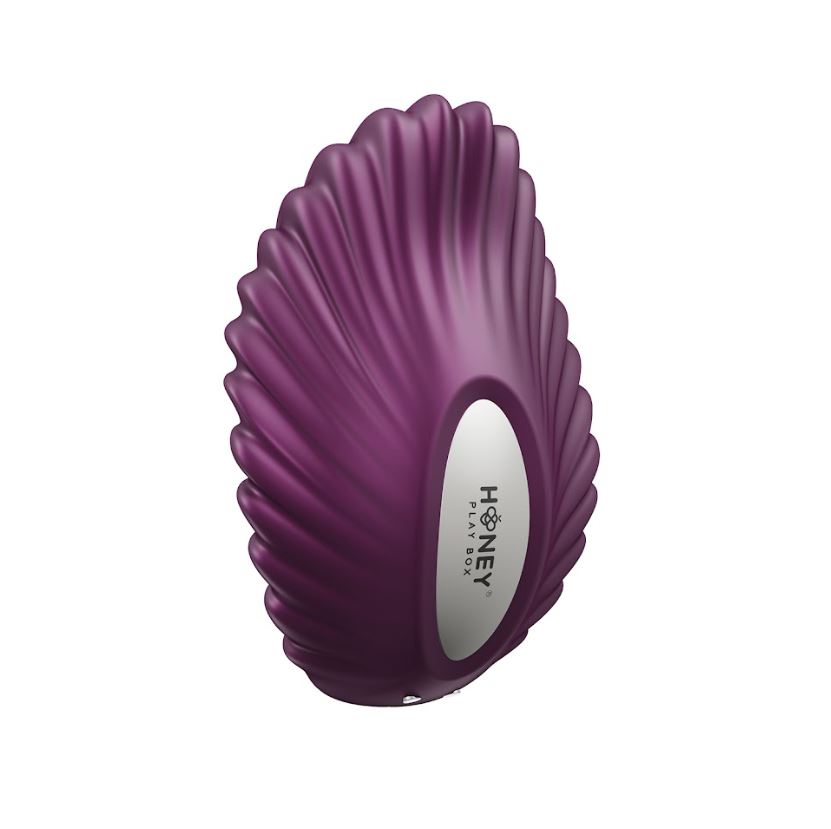Purple shell-shaped vibrator with a white oval logo.