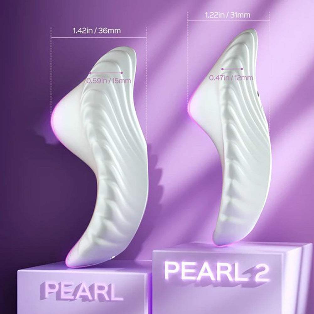 Two white, curved vibrators with dimensions labeled, displayed on purple pedestals.